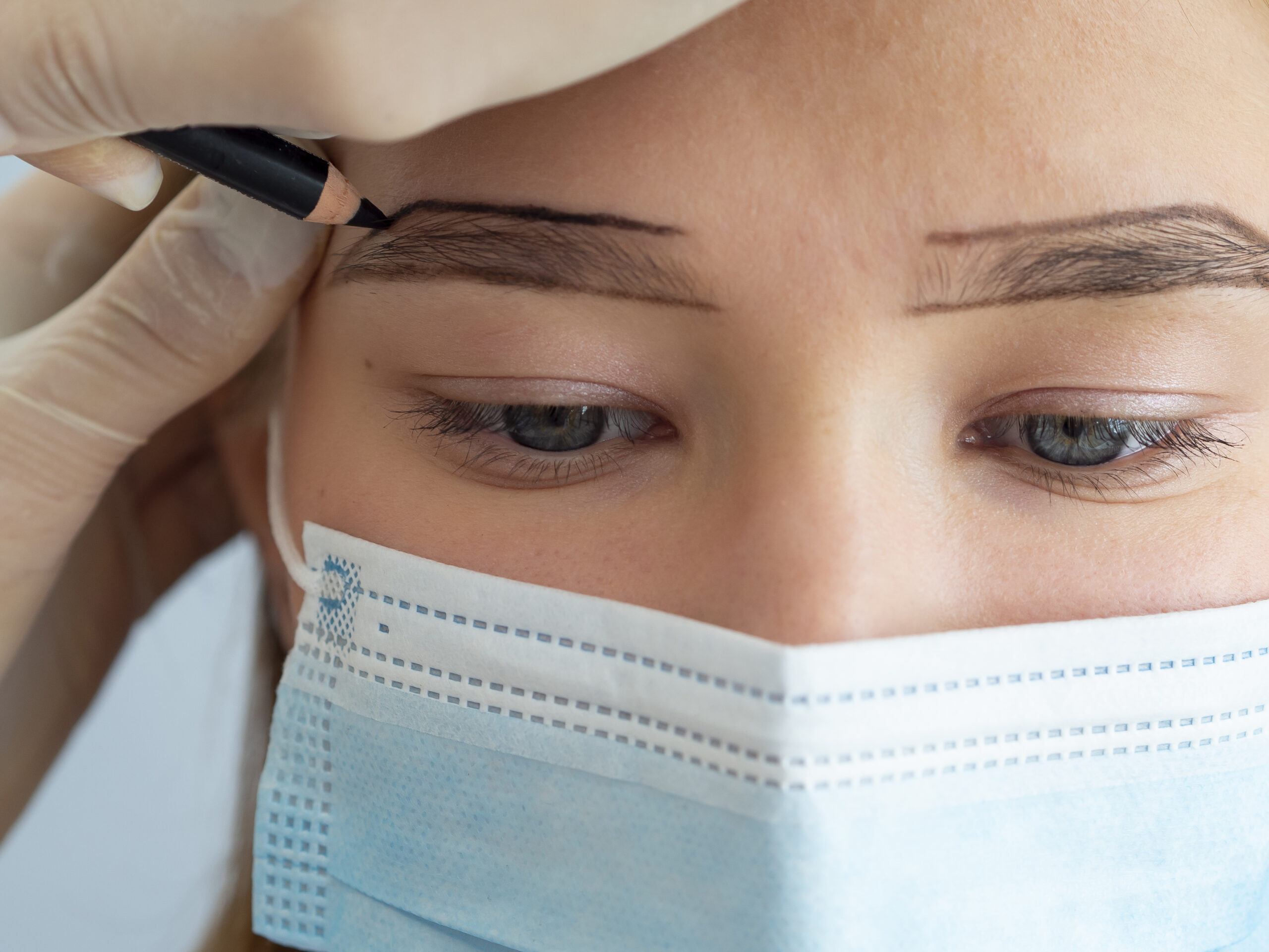 client going through microblading treatment scaled